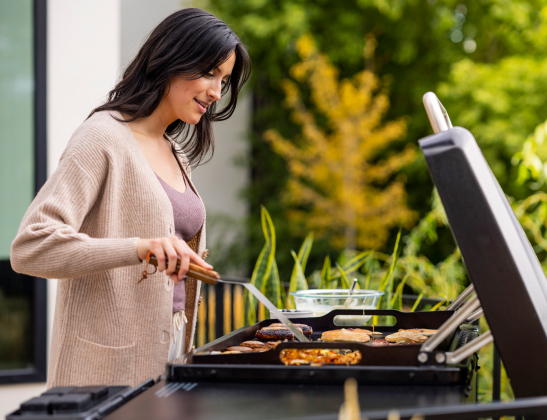 woman cooking on the traeger flatrock grill